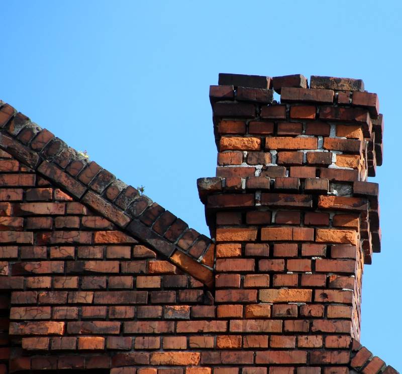 Damaged chimney on an Chevy Chase home showing cracks and missing mortar